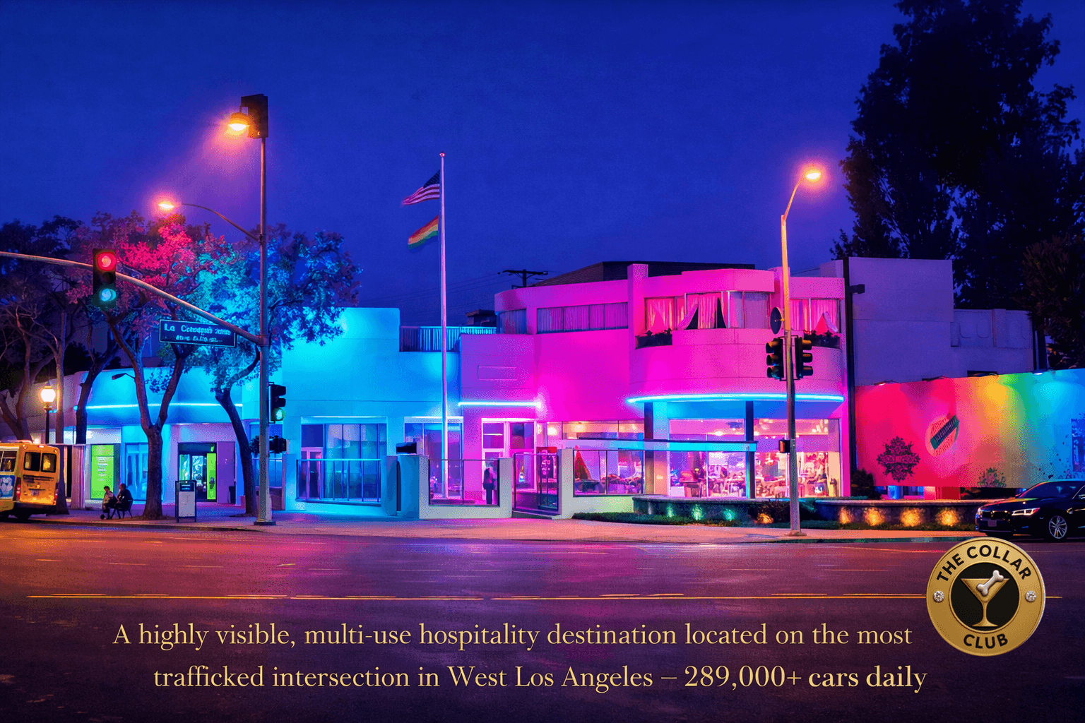Colorful building illuminated at night with trees and streetlights, vibrant pink, blue, and purple lights, and a flagpole in front.