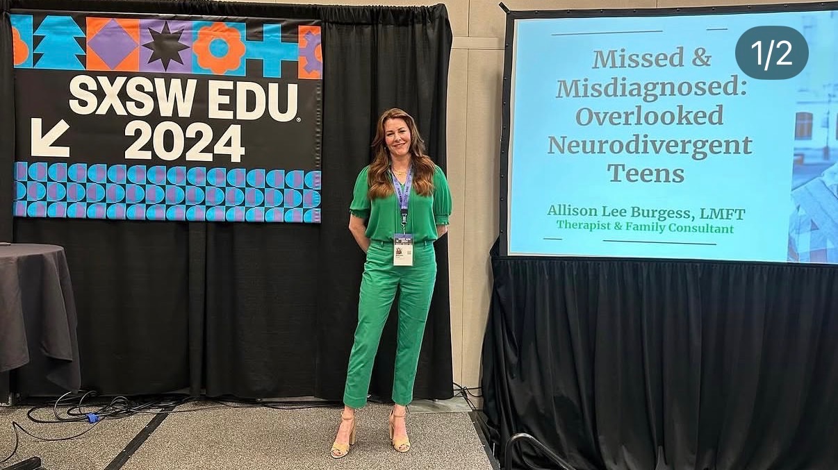 Woman in green scrubs standing next to presentation screen at SXSW EDU 2024 conference.