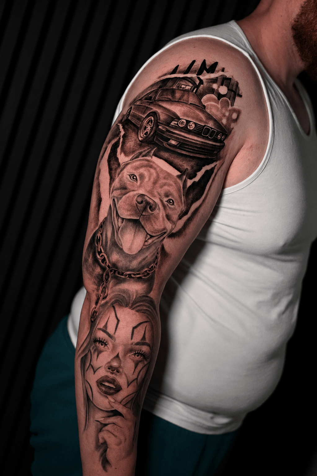 Tattoo sleeve featuring a dog, a car, and a woman's face on a person's arm.