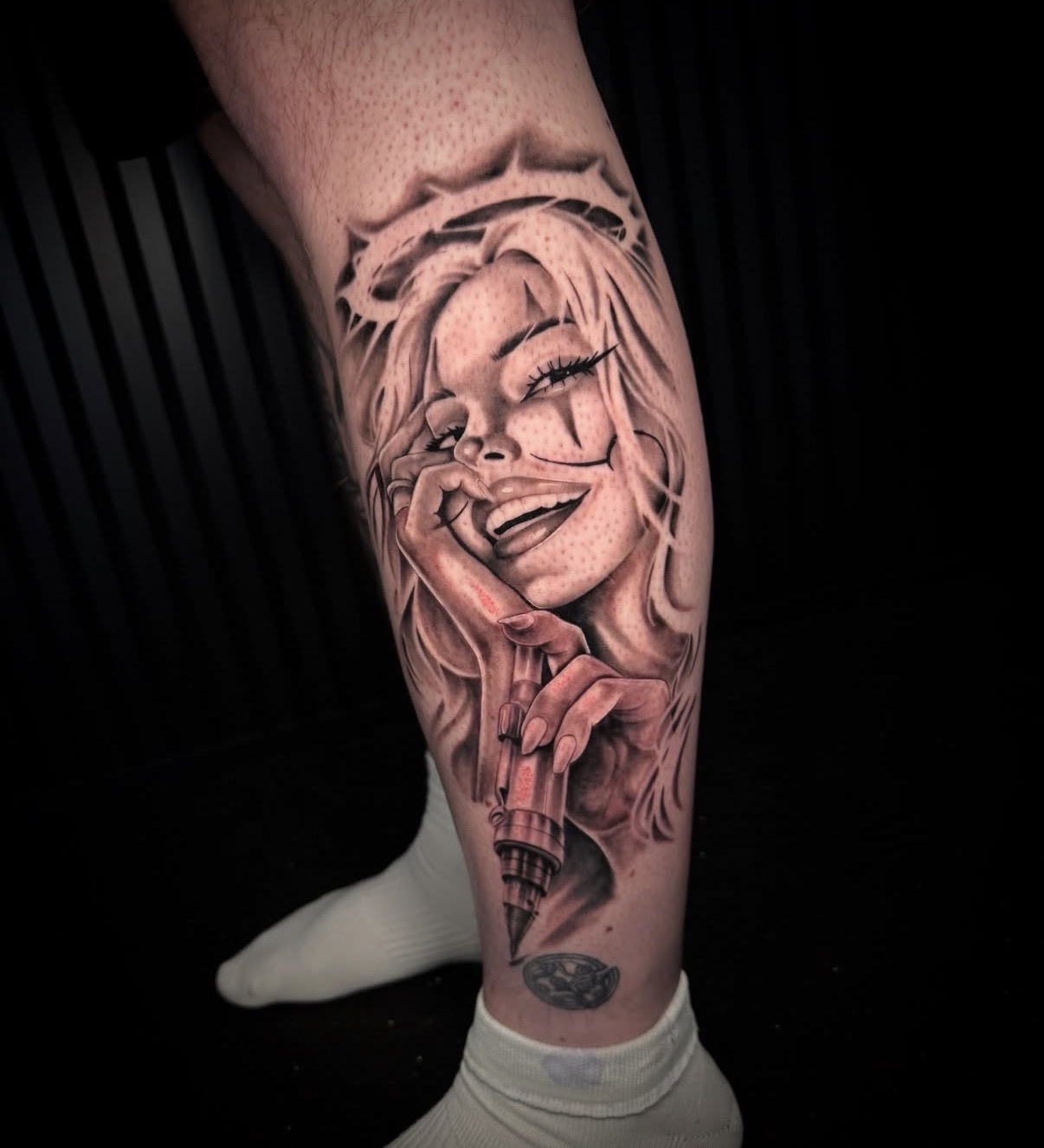Tattoo of a smiling woman with long hair holding an ice cream cone, on a person's leg, with a dark background.